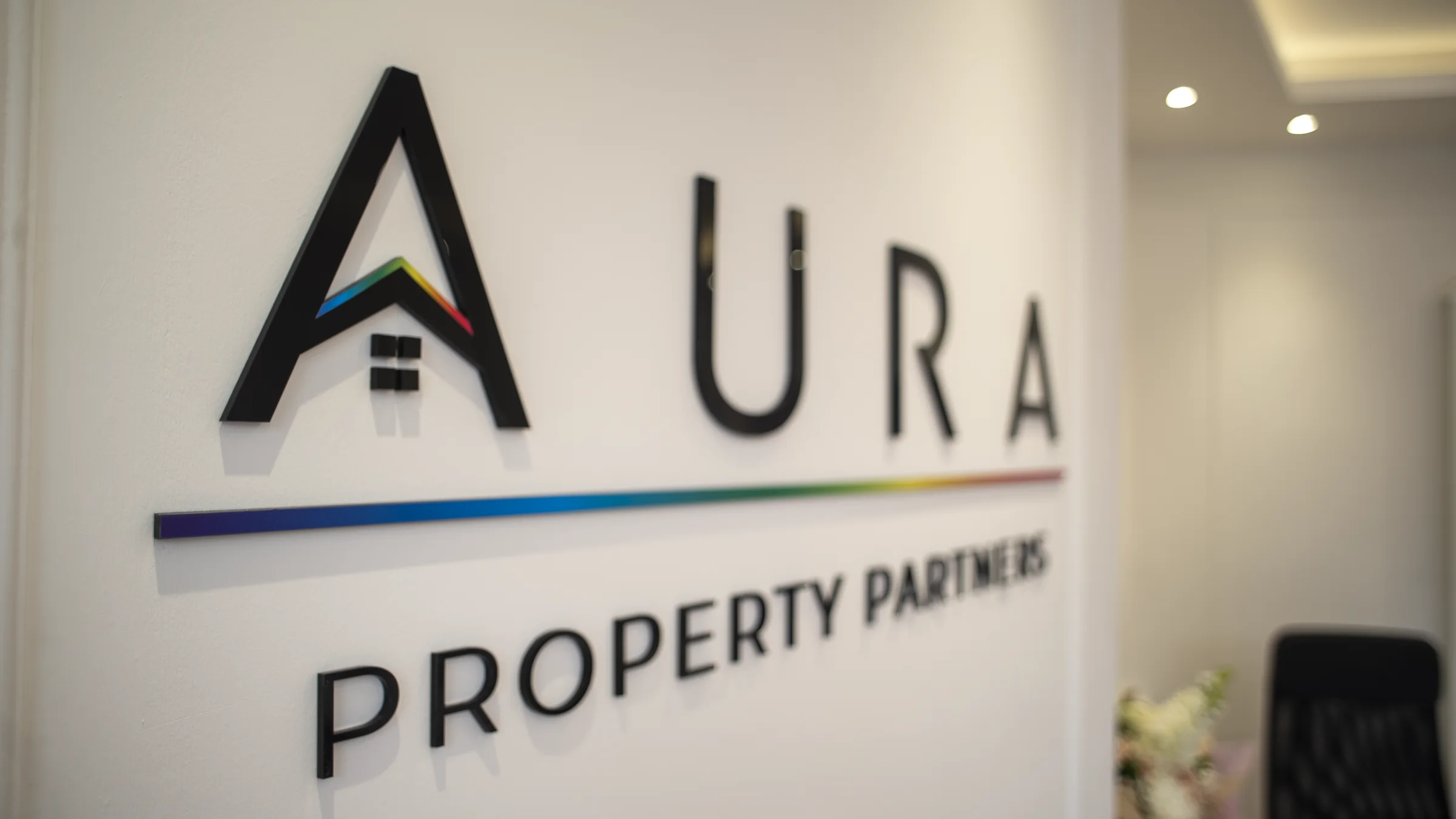 Aura Property Partners office wall sign
